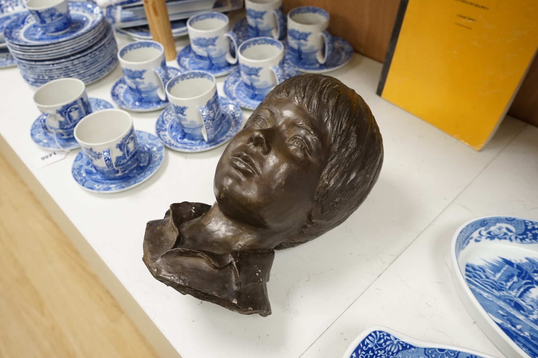 A bronzed head of a child, unsigned, 33cm high